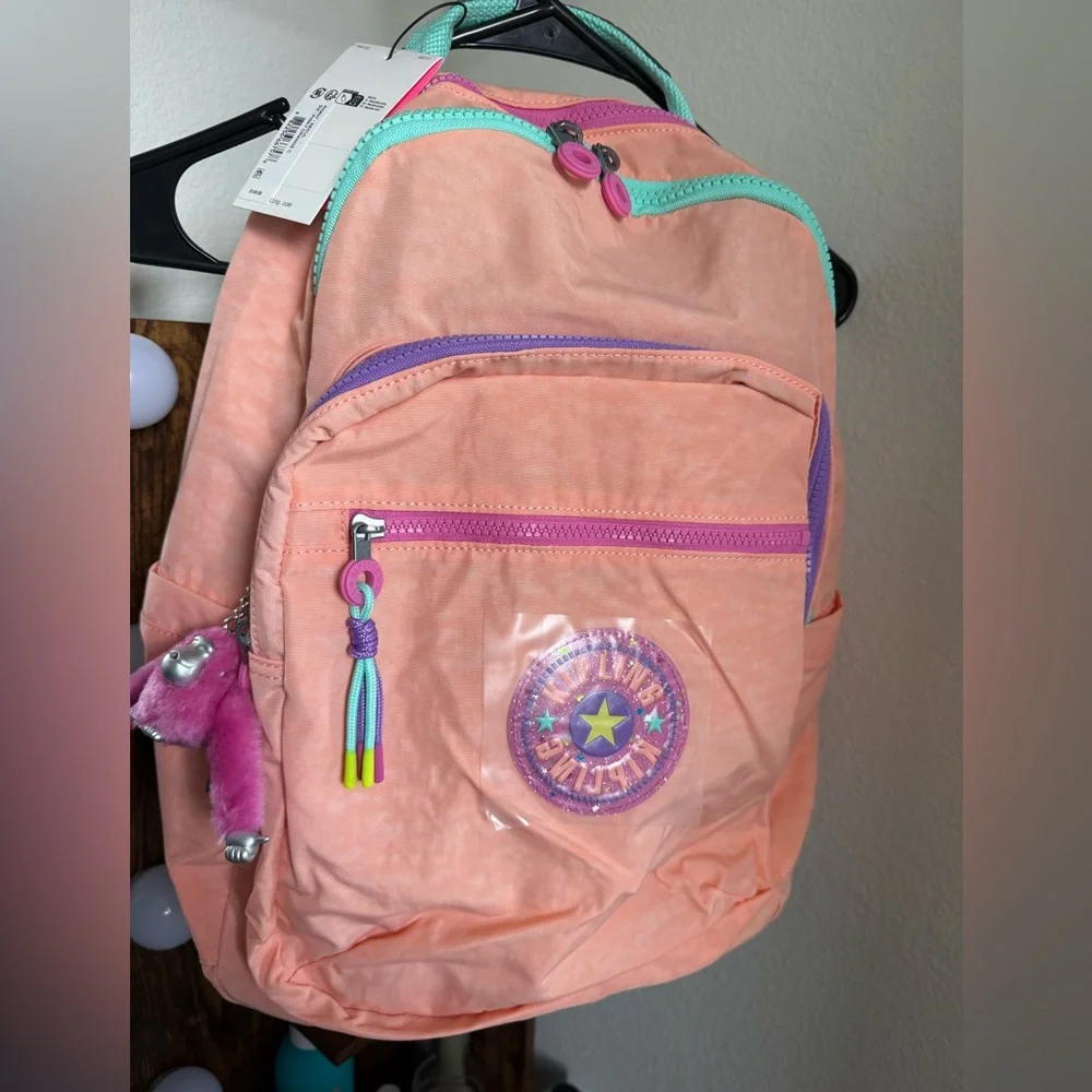 Kipling Coral Pink Backpack with Teal Trim and Purple Accents